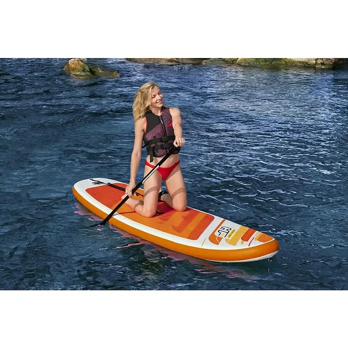 Hydro-Force SUP-daska Aqua Journey - D x Š x V: 274 x 76 x 12 cm, Nosiva sila: 100 kg, Napuhljivo - Plava žena kleči na narančastoj dasci za stojeće veslanje u vodi, držeći veslo. Nosi prsluk za spašavanje.