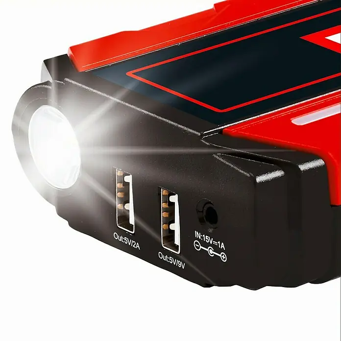 Einhell Kit de arranque CE-JS 12 - 12 V, Corriente máx. de carga: 400 A - Primer plano de un arrancador con luz LED, USB y entradas de alimentación, ideal para uso en movilidad.