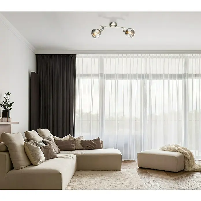Tween Light Deckenstrahler Ball - 8 W, E14, 2 Stk. - Nahaufnahme einer modernen Deckenleuchte mit zwei Spots, die das Wohnzimmer mit einem beigen Sofa und Vorhängen beleuchtet.