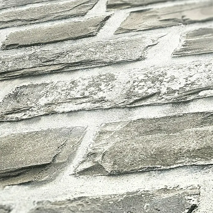 AS Creation Elements Vliesbehang - Crème/grijs, Steenlook, 10,05 x 0,53 m - Een close-up van een muur met grijze steenbekleding, met een rustieke en robuuste textuur.